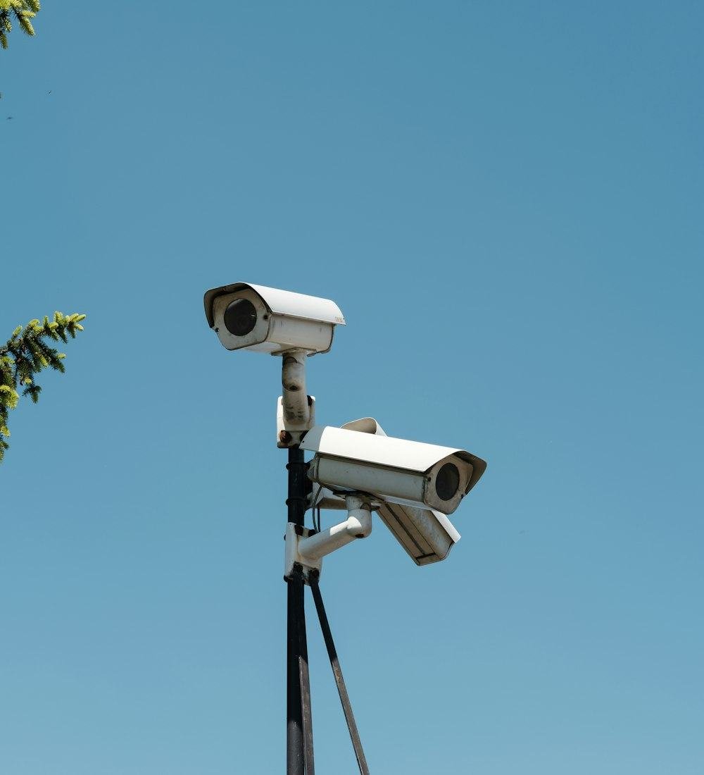 Two outdoor CCTV cameras mounted on a pole