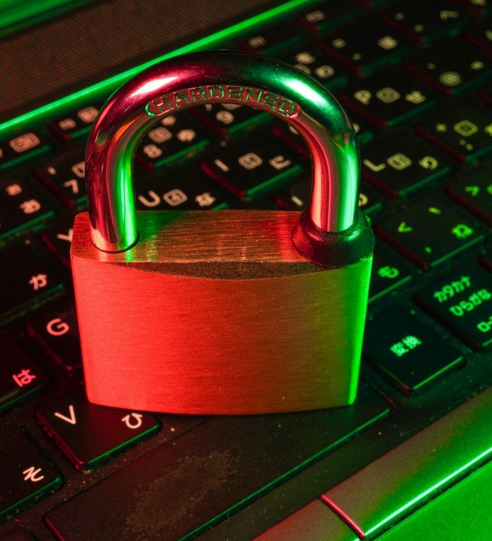 A red padlock resting on a computer keyboard